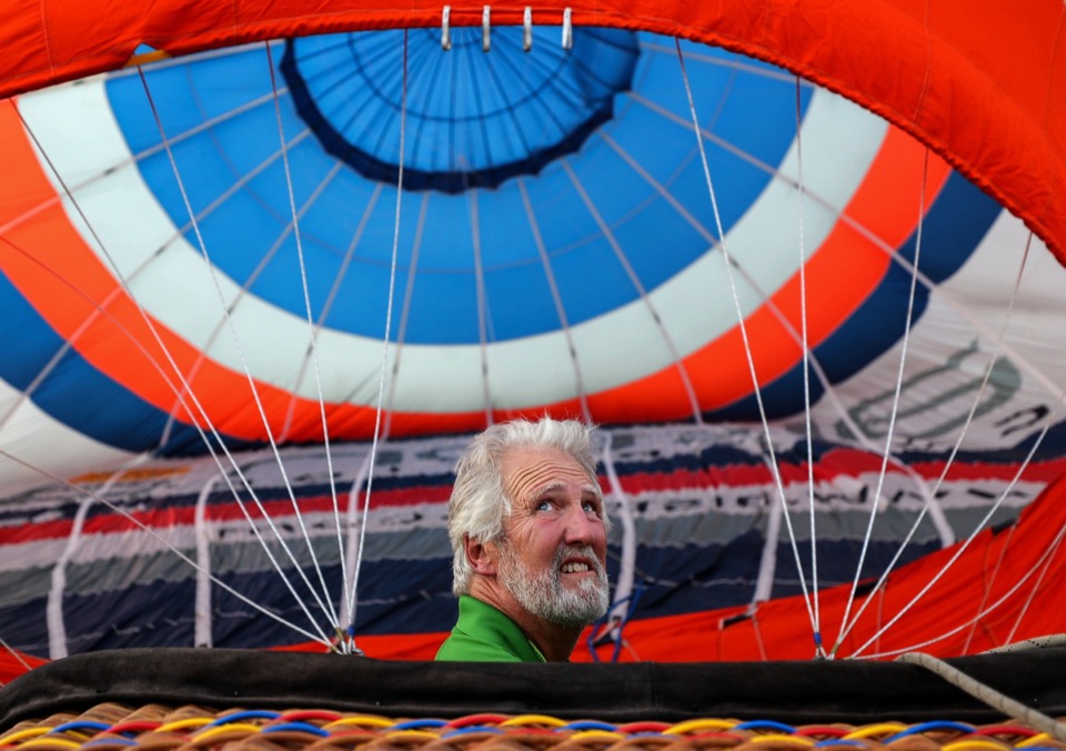<strong>Keith Erwin checks the wind while filling up his hot air balloon during the first day of the Bluff City Balloon Jamboree in Collierville on June 18, 2021.</strong> (Patrick Lantrip/Daily Memphian)