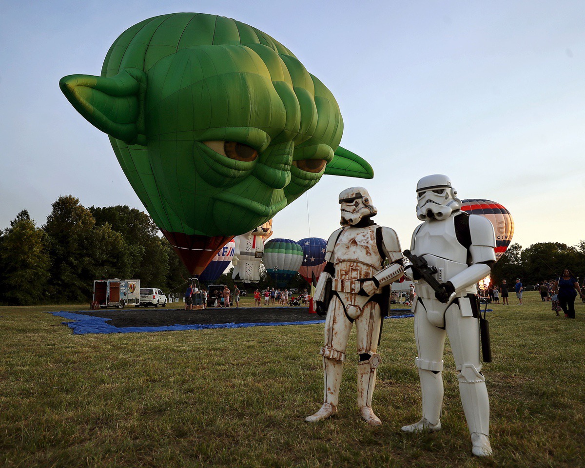 <strong>A hot air balloon shaped like Yoda keeps an eye on a pair of Stormtroopers during the first day of the Bluff City Balloon Jamboree in Collierville on June 18, 2021.</strong> (Patrick Lantrip/Daily Memphian)