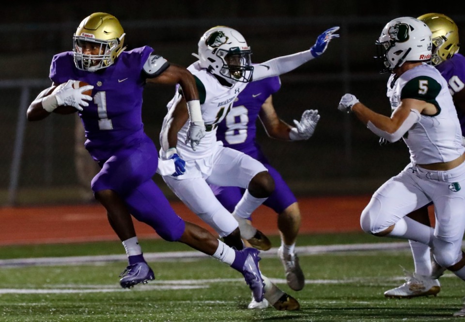 <strong>CBHS running back Dallan Hayden (left) runs by the Briarcrest defense during action in their high school football game Friday, Oct. 4, 2019.</strong> (Mark Weber/Daily Memphian file)