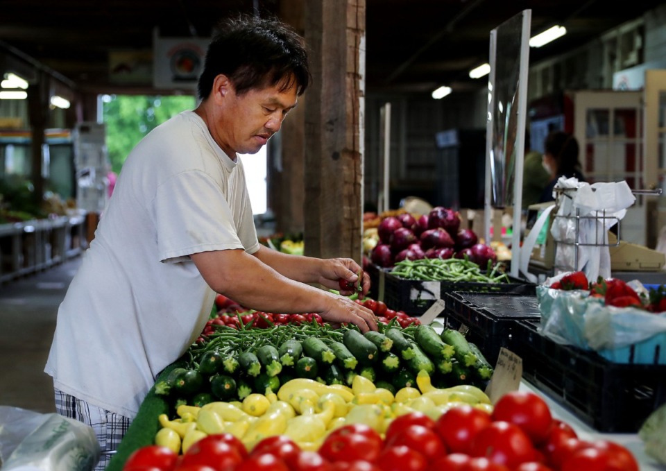 <strong>Zong Vue sets up his stand at the Agricenter's Farmers Market on June 1, 2021.&nbsp;The Shelby County Health Department will open its annual senior farmers market next month.</strong> (Patrick Lantrip/Daily Memphian)