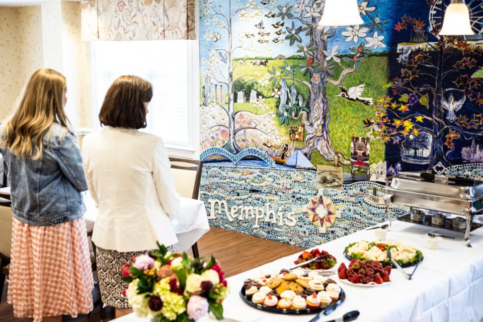 <strong>People admire the Memphis history mural in the memory care dining room at Trezevant on June 24.</strong> (Brad Vest/ Special to The Daily Memphian)