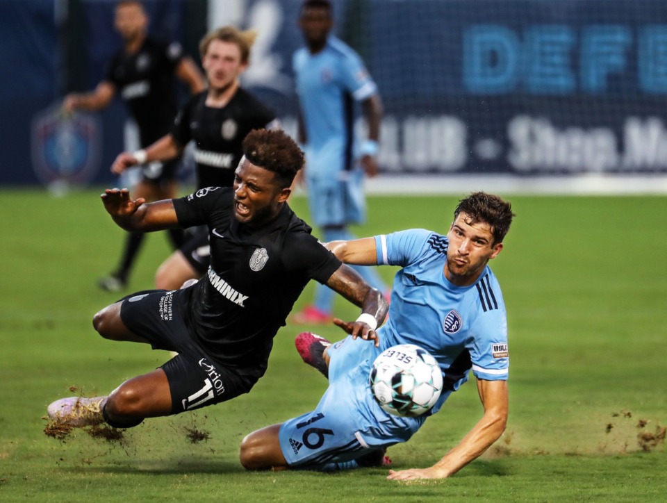 <strong>Memphis 901 FC forward Michael Salazar (11) gets tripped up by Sporting KC II defender Graham Smith (16) during a June 26, 2021 home match.</strong> (Patrick Lantrip/Daily Memphian)