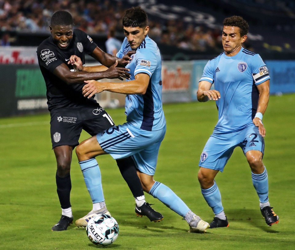 <strong>Memphis 901 FC forward Kadeem Dacres (10) fights through a pair of Sporting KC II defenders during a June 26, 2021 home game.</strong> (Patrick Lantrip/Daily Memphian)