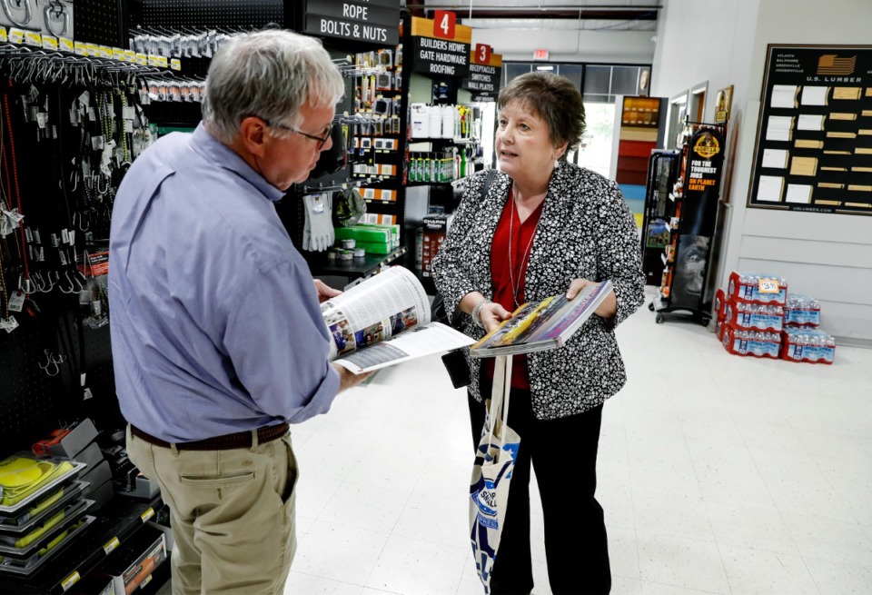<strong>Arlington Chamber of Commerce Director Tonia Howell hands out city guides and pamphlets to Sunrise Builder Supply owner Ronney Daniel on Tuesday, June&nbsp; 29.</strong> (Mark Weber/Daily Memphian)
