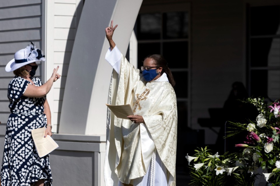 <strong>The Rev. Dr. Dorothy Sanders Wells (right) greets arrivals to St. George&rsquo;s Episcopal Church outdoor Easter service in Germantown on April 4. COVID forced many adaptations to church services.</strong> (Brad Vest/Daily Memphian file)