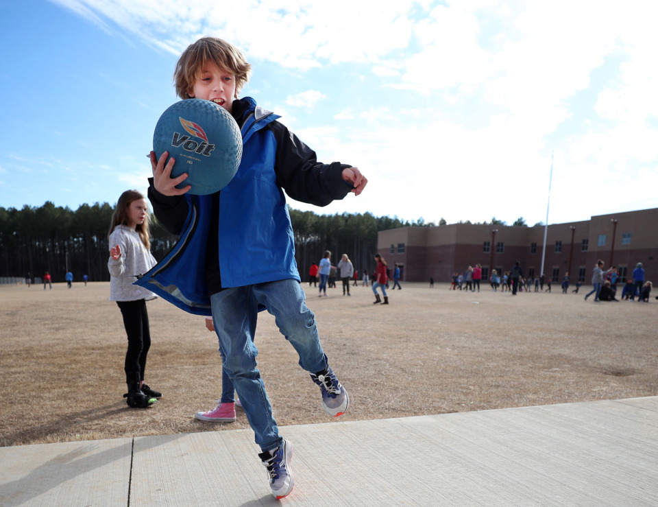 <strong>Lakeland Middle Preparatory School fifth-grader Porter Spiceland plays four-square with his classmates during recess. With the news that Lakeland will attempt to move forward on funding a high school adjacent to the middle school, many parents are excited about extended school choices in the Lakeland area.</strong> (Houston Cofield/Daily Memphian)