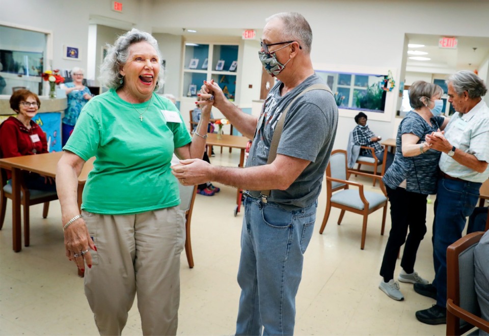 <strong>Page Robbins Adult Day Center participants Elise (left) and Mike (right) dance to Patsy Cline songs on Tuesday, July 6, 2021.&nbsp;To socially distance through the pandemic, Page Robbins reduced its client base by 25%.</strong> (Mark Weber/The Daily Memphian)