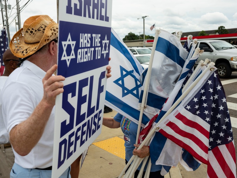 <strong>Israeli and American flags are handed out during a rally Sunday, July 11, for Israel organized by Memphis Friends of Israel at the intersection of Poplar and Ridgeway.</strong> (Brad Vest/Special to The Daily Memphian)