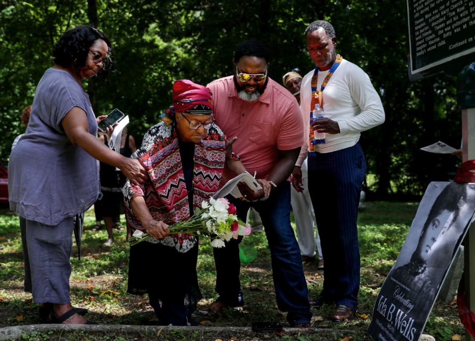 <strong>Mother Georgia King (center) lays flowers on the grave of lynching victim Thomas Moss at Zion Cemetery on Thursday, July 15.</strong>&nbsp;(Patrick Lantrip/Daily Memphian)