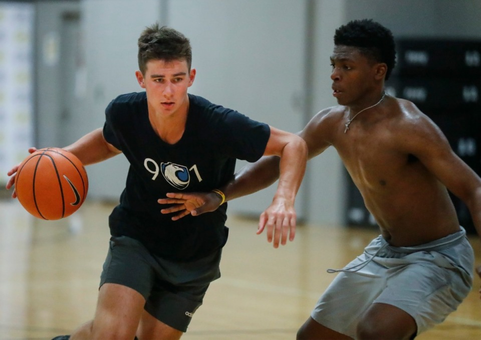 <strong>Justin Morgan (left) drives by Team Thad teammate Chandler Jackson during practice on Tuesday, July 6.&nbsp;Team Thad is 2-1 through the week, with four more games to go, at the Nike EYBL season in North Augusta, South Carolina.</strong> (Mark Weber/Daily Memphian)