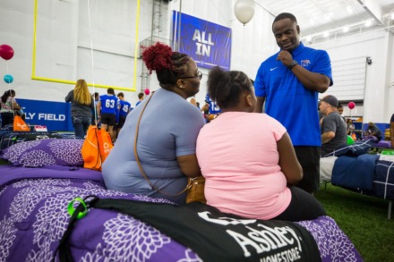 <strong>University of Memphis Football Assistant Coach Anthony Jones speaks with a family members who were surprised to receive free beds and bedding during the Hope to Dream football minicamp at the Univerisity of Memphis South Campus on July 17, 2021.</strong> (Ziggy Mack/Special to The Daily Memphian)