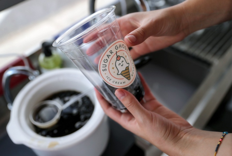 <strong>Olivia Evans fills a cup with tapioca boba while making a bubble tea at Sugar Ghost's Broad Avenue food truck July 16, 2021.</strong> (Patrick Lantrip/Daily Memphian)