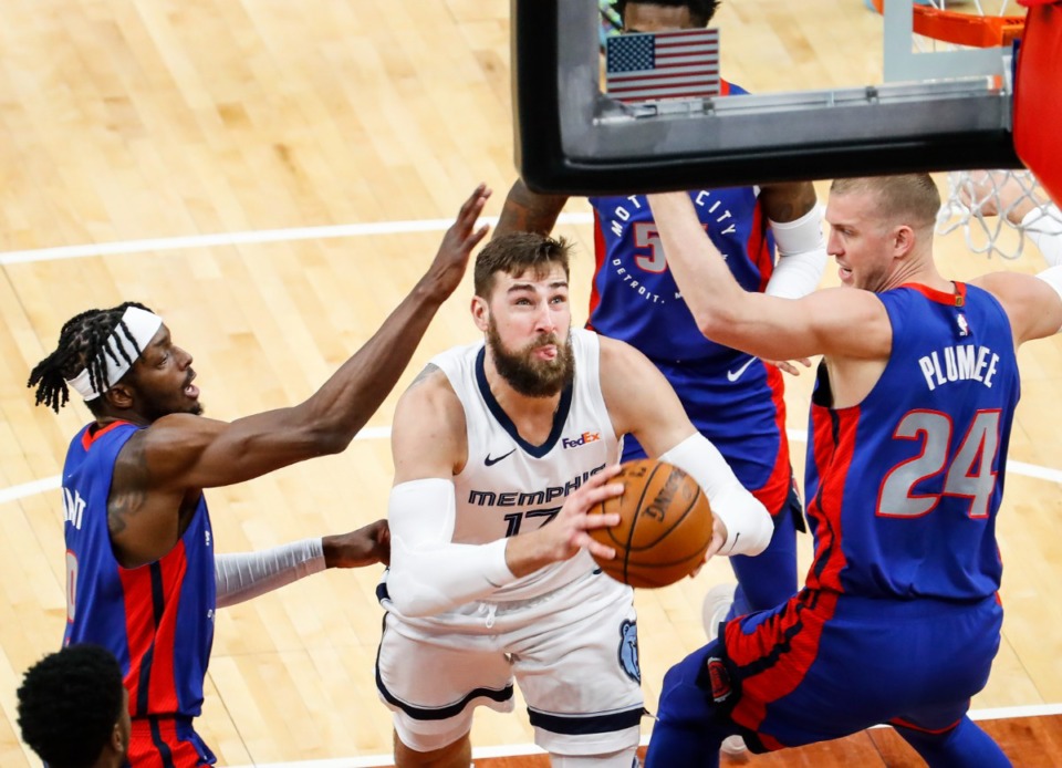 <strong>Memphis Grizzlies center Jonas Valanciunas (middle) drives to the basket against Detroit Pistons defenders Isaiah Stewart (left) and Mason Plumlee (right) during action on Friday, Feb. 19, 2021.</strong> (Mark Weber/The Daily Memphian)