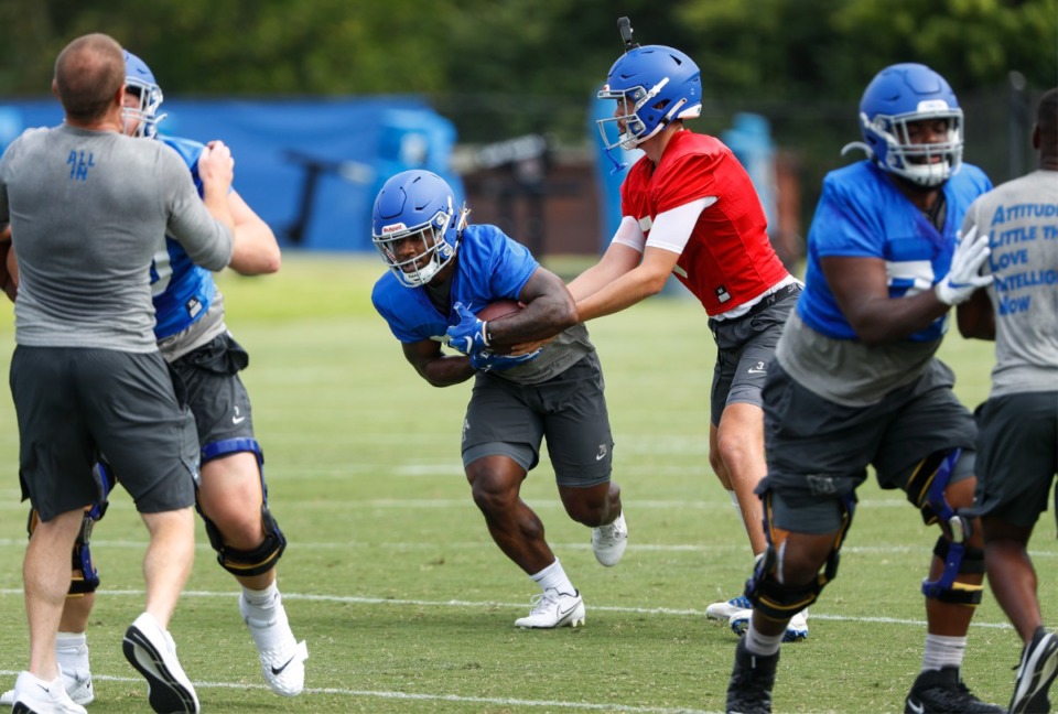 <strong>Memphis quarterback Grant Gunnell (right) hands off to running back Brandon Thomas (left) during first day of practice on Friday, Aug. 6, 2021.</strong> (Mark Weber/The Daily Memphian)
