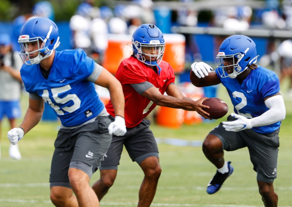 <strong>Memphis quarterback Petter Parrish (left) hands off to running back Julian Barnett (right) during first day of practice on Friday, Aug. 6, 2021.</strong> (Mark Weber/The Daily Memphian)