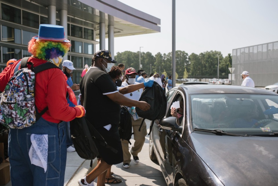 <strong>Volunteers handed out backpacks and other school resources for families driving by Raleigh Springs Civic Center, Saturday, Aug 7.</strong> (Lucy Garrett/Special to The Daily Memphian)