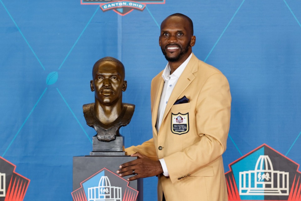 <strong>Isaac Bruce, a member of the Pro Football Hall of Fame Centennial Class, poses with his bust during the induction ceremony at the Pro Football Hall of Fame, Saturday, Aug. 7, 2021, in Canton, Ohio.</strong> (Ron Schwane/AP)