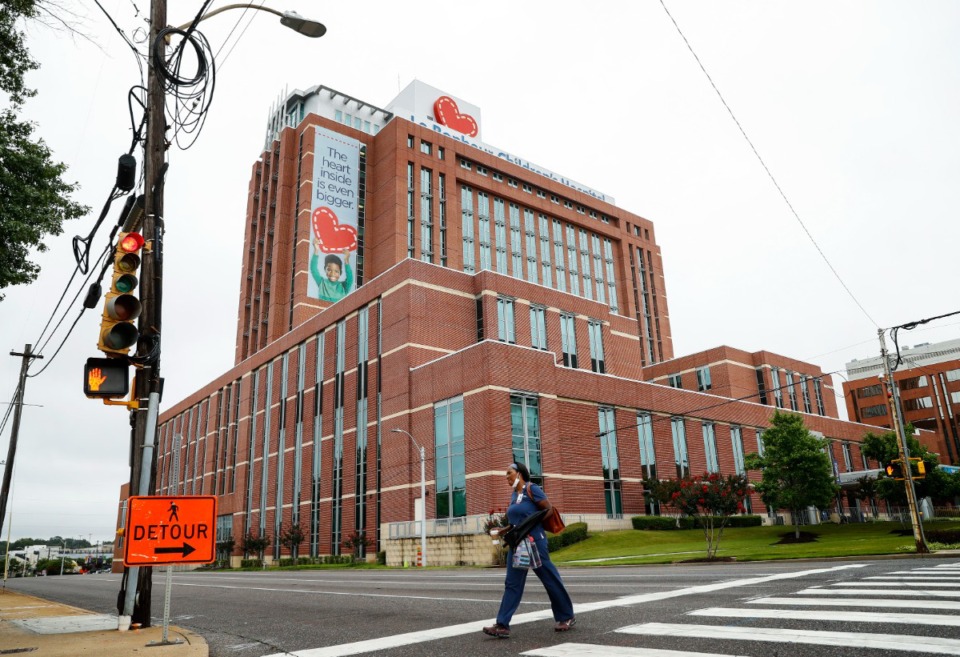 <strong>A Le Bonheur Children's Hospital staff member crosses Poplar Ave., on Monday, July 19, 2021.The number of children sick with COVID at the hospital has more than doubled in a week.</strong> (Mark Weber/The Daily Memphian)