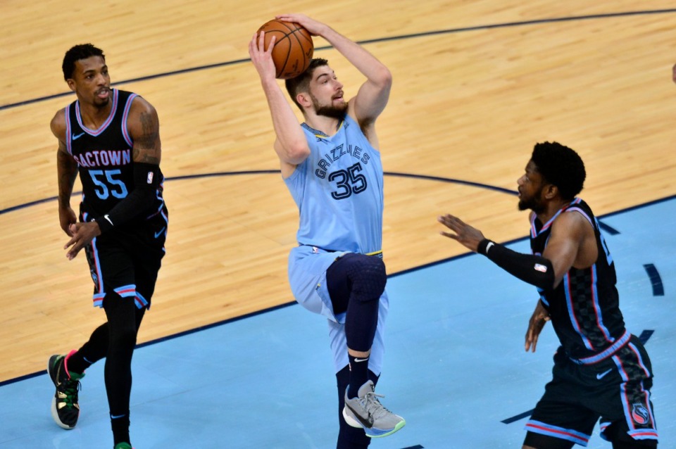 <strong>Memphis Grizzlies center Killian Tillie (35) looks to shoot between Sacramento Kings forward Chimezie Metu (right) and guard Delon Wright (55) in the first half of an NBA basketball game Friday, May 14, 2021, at FedExForum.</strong> (Brandon Dill/AP file)