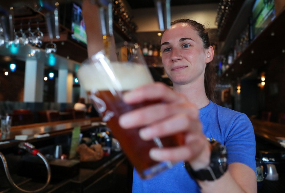 <strong>Jessica Ruff pours a beer at Boscos on Overton Square.&nbsp;</strong>(Patrick Lantrip/The Daily Memphian)