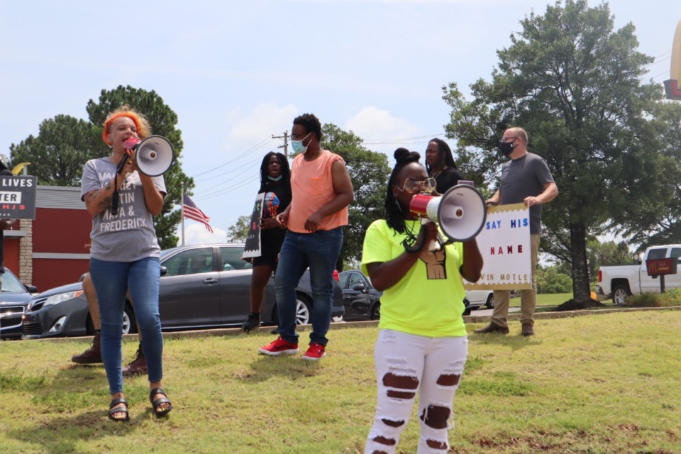 <strong>Demonstrators including Barbara Buress (right) and LJ Abraham (left) shout at customers of the Kroger gas station at 6660 Poplar Ave., where a man was shot last weekend. Some of the demonstrators circled the station in their cars, playing loud music and others parked vehicles in front of gas pumps.</strong> (Rob Moore/Daily Memphian)
