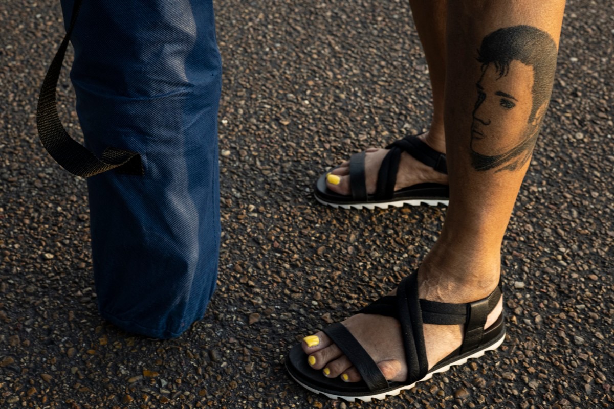<strong>&ldquo;When I come back next year there will be more added to it,&rdquo; Elvis fan Becky Cornelius said about her Elvis tattoo as she stood outside Graceland during the candlelight vigil Sunday, Aug. 15, 2021.</strong> (Brad Vest/Special to The Daily Memphian)