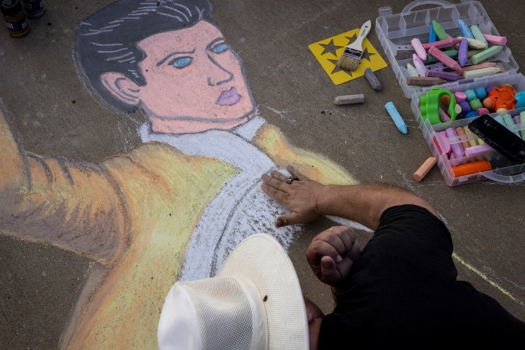 <strong>Greg Damron works on sidewalk art of Elvis along Elvis Presley Boulevard during the Elvis Week 2021 Candlelight Vigil, Sunday, Aug. 15.</strong> (Brad Vest/Special to The Daily Memphian)