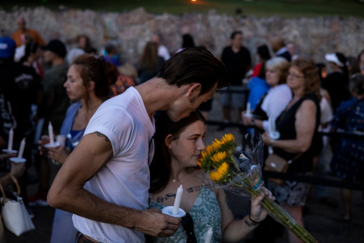 <strong>Kyler Campbell (left) kisses his girlfriend, Ashlyn Farris, while waiting in line along Elvis Presley Boulevard Sunday, Aug. 15, during the Elvis Week Candlelight Vigil. The annual vigil near Presley&rsquo;s grave at Graceland commemorates the anniversary of the singer&rsquo;s death on Aug. 16, 1977.</strong> (Brad Vest/Special to The Daily Memphian)