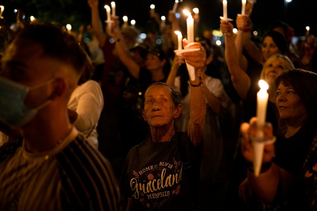 <strong>Fans hold their candles high Sunday, Aug. 15, 2021 as they stand along Elvis Presley Boulevard during the Elvis Week 2021 Candlelight Vigil. The vigil marks the anniversary of the singer&rsquo;s death on Aug. 16, 1977.</strong> (Brad Vest/Special to The Daily Memphian)