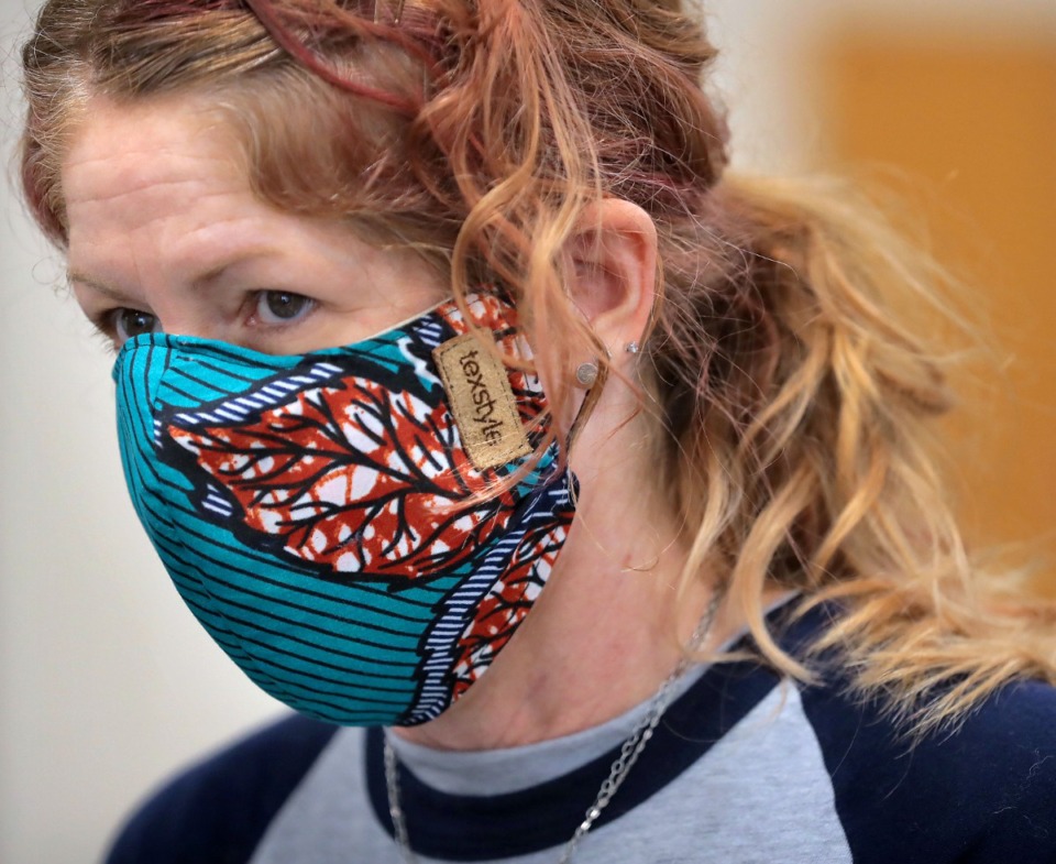 <strong>Terri Harris wears a mask made by a local artist as she volunteers during a food drive at the University of Memphis International Center on May 2, 2020.</strong> (Jim Weber/Daily Memphian file)