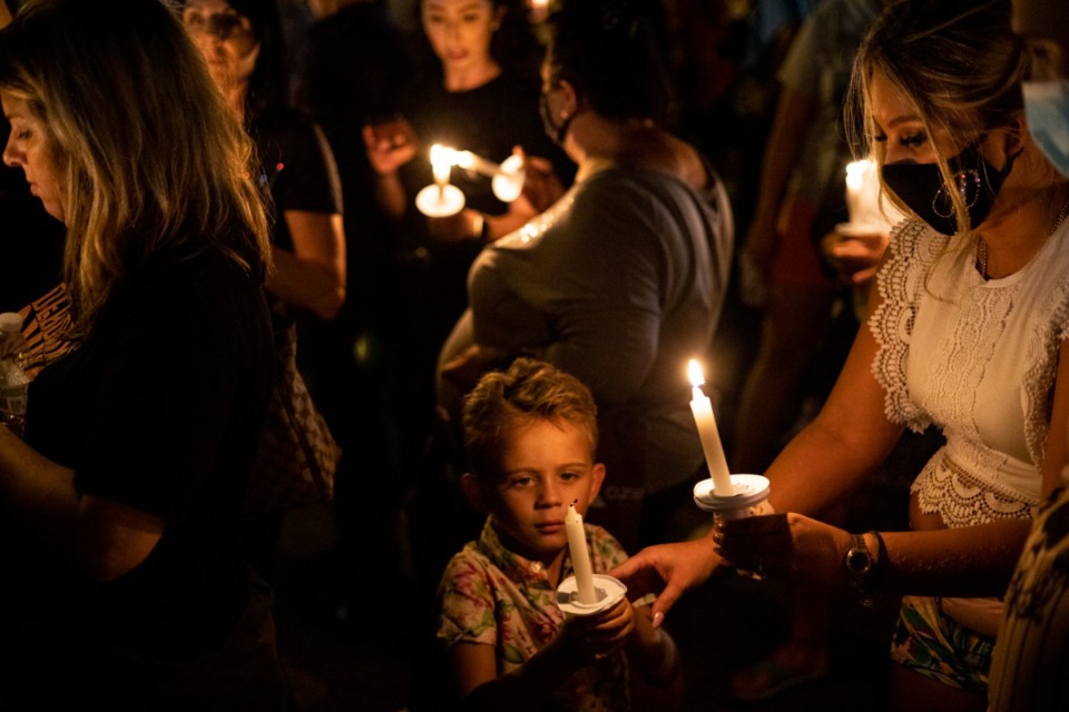 <strong>People light candles along Elvis Presley Boulevard during the Elvis Week 2021 candlelight vigil on Sunday, Aug. 15. The annual vigil marks the anniversary of the singer&rsquo;s death on Aug. 16, 1977.</strong> (Brad Vest/Special to The Daily Memphian)