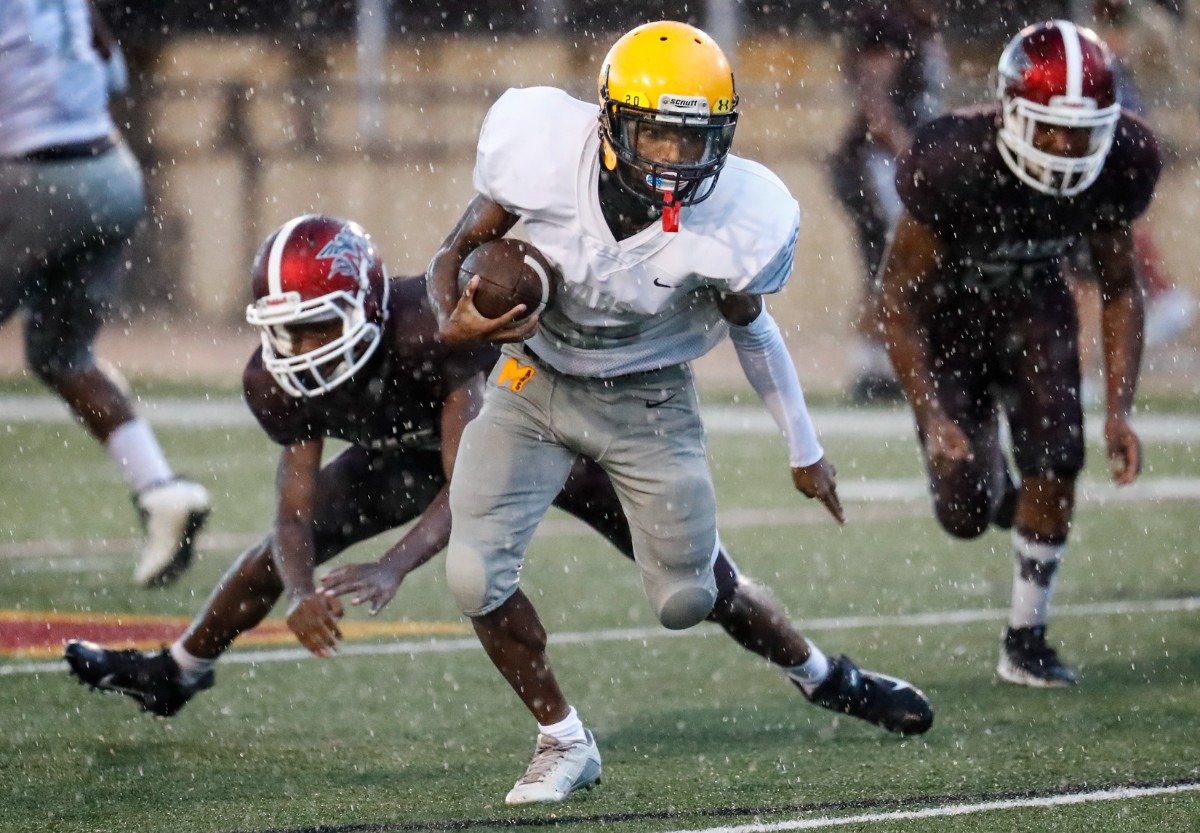 <strong>MAHS running back Jahiem Jackson (middle) runs by the MASE defense for a touchdown on Thursday, Aug. 19, 2021.</strong> (Mark Weber/The Daily Memphian)