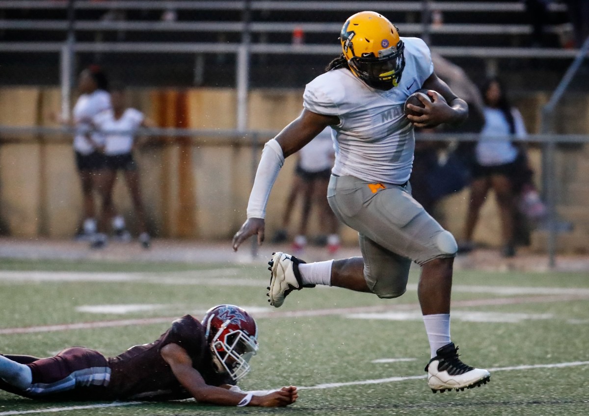 <strong>MAHS defensive lineman Charles Perkins (right) runs by MASE&rsquo;s Kendarious Love (left) for a touchdown after recovering a fumble on Thursday, Aug. 19, 2021.</strong> (Mark Weber/The Daily Memphian)