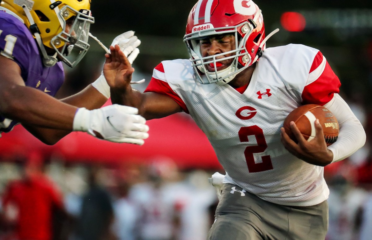 <strong>Germantown running back Malik Young (2) tries to dodge a CBHS defender during an Aug. 21, 2021 game.</strong> (Patrick Lantrip/Daily Memphian)