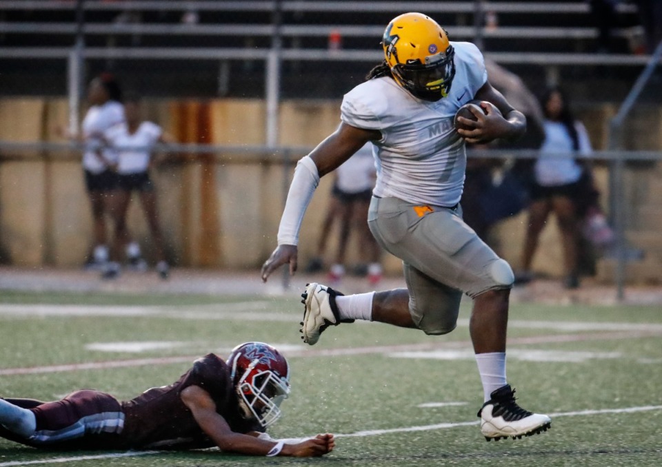 <strong>MAHS defensive lineman Charles Perkins (right) runs by the MASE&rsquo;s Kendarious Love (right) for a touchdown on Thursday, Aug. 19, 2021.</strong> (Mark Weber/The Daily Memphian)