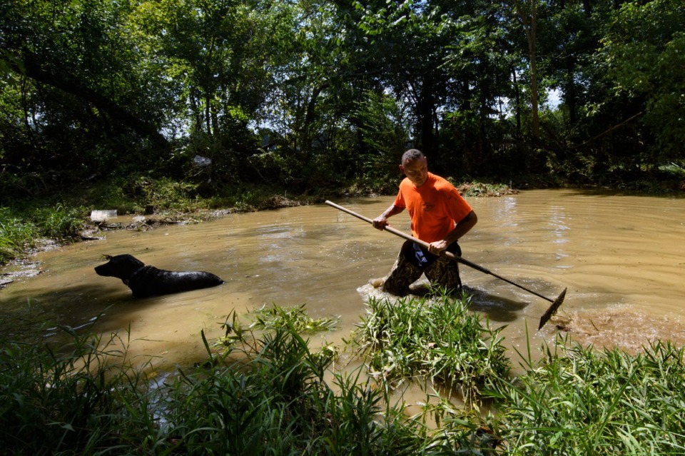 <strong>Dustin Shadownes, of Ashland City Fire Department, searches a creek for missing persons along with a cadaver dog, Monday, Aug. 23, 2021, in Waverly, Tenn.</strong> (John Amis/AP)