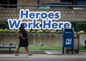 <strong>A Regional One Health staff member walks along Jefferson Avenue, on July 19.&nbsp;The County Commission is giving hospital enough funding to hire enough skilled professionals on a temporary contract to open up 21 more beds for 13 weeks.</strong> (Mark Weber/The Daily Memphian)