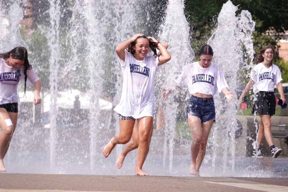 <strong>As temperatures soared into the mid-90s on Monday, Aug. 23, a group ran through the fountain to cool off on the University of Memphis campus. Many students attended in-person classes for the first time Monday in several months due to the coronavirus pandemic.</strong> (Karen Pulfer Focht/Special to the Daily Memphian)