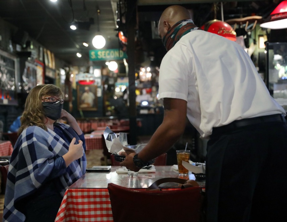<strong>Denise Tate gets a plate of ribs for lunch at Rendezvous Dec. 1, 2020.</strong> (Patrick Lantrip/Daily Memphian file)
