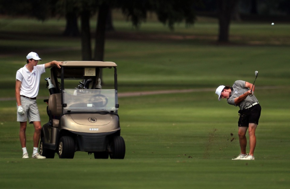 <strong>Davis Byrd hits from the fairway while Clarence Chapman looks on at the Ronnie Wenzler golf tournament at Windyke County Club on Aug. 26, 2021.</strong> (Patrick Lantrip/Daily Memphian)