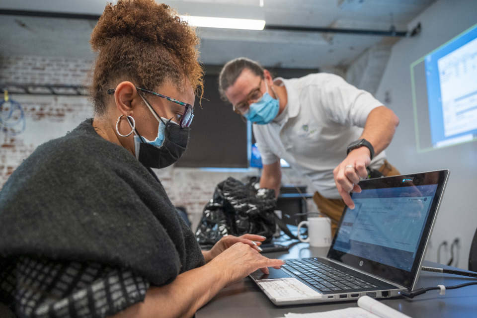 <strong>Instructor Blair Perry, right, helps Camille Lee-Wright in the IT Foundations course at Tech901 at the Crosstown Concourse, Monday, Aug. 23, 2021. Memphis is considered one of the most diverse cities for IT in the nation, according to a CompTIA study.</strong> (Greg Campbell/Special to Daily Memphian)