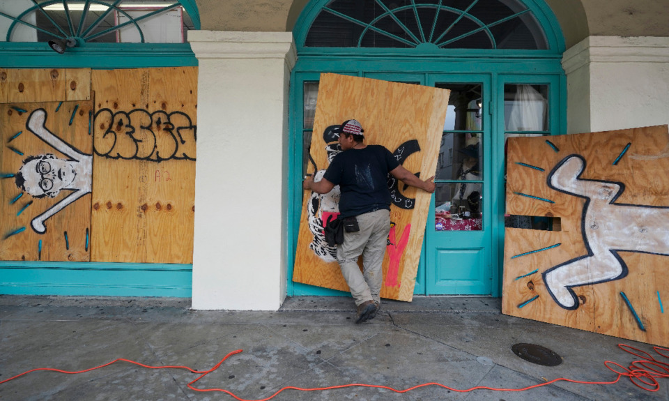 <strong>In preparation for Hurricane Ida, a worker attaches protective plywood to the windows and doors of a business in the French Quarter in New Orleans, Saturday, Aug. 28, 2021.</strong> (AP Photo/Eric Gay)