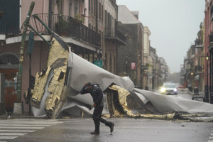 <strong>A man passes by a section of roof that was blown off of a building in the French Quarter by Hurricane Ida winds, Sunday, Aug. 29, 2021, in New Orleans.</strong> (AP Photo/Eric Gay)