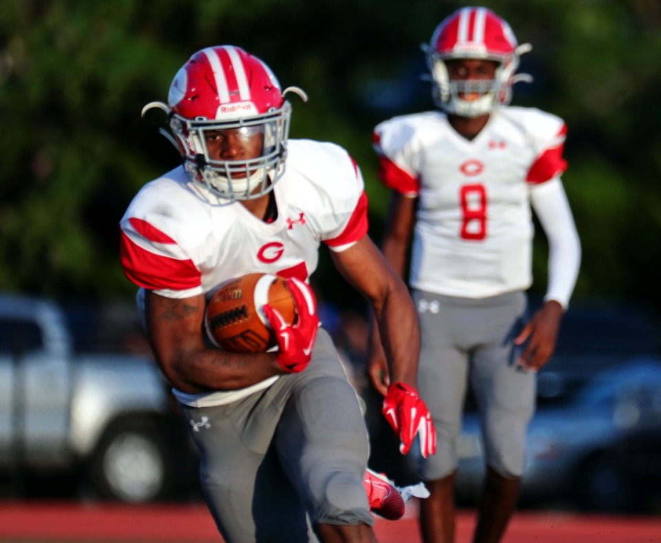 <strong>This week Germantown moved up to No. 4. Red Devils&rsquo; receiver Joshua Davis (27) runs upfield during an Aug. 21, 2021 game at CBHS.</strong> (Patrick Lantrip/Daily Memphian)