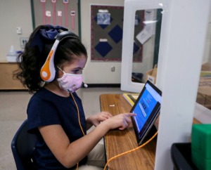 <strong>A masked Riverwood Elementary student works on her tablet March 1, 2021.</strong> (Patrick Lantrip/Daily Memphian file)