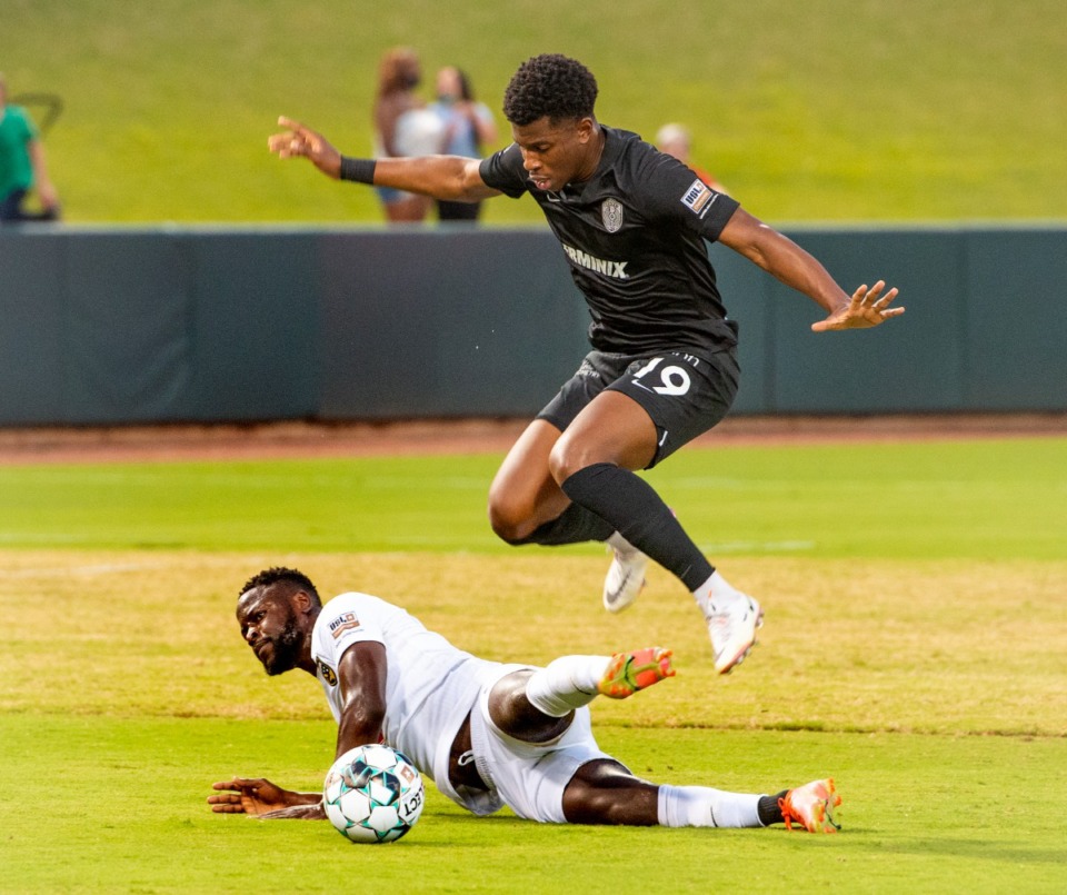 <strong>Memphis 901 FC's Dre Fortune avoids a collision with Birmingham Legion's Neco Brett in Saturday's match. Memphis defeated Birmingham 3-2.</strong> (Greg Campbell/Special to The Daily Memphian)