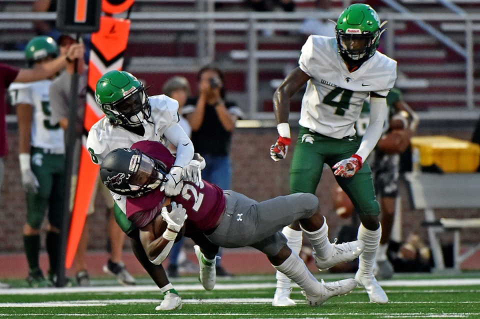 <strong>A Collierville back is taken down by a couple of White Station Spartans, including Shamari Covington (4), on Friday, Sept. 3, 2021.</strong> (Justin Ford/Special to The Daily Memphian)