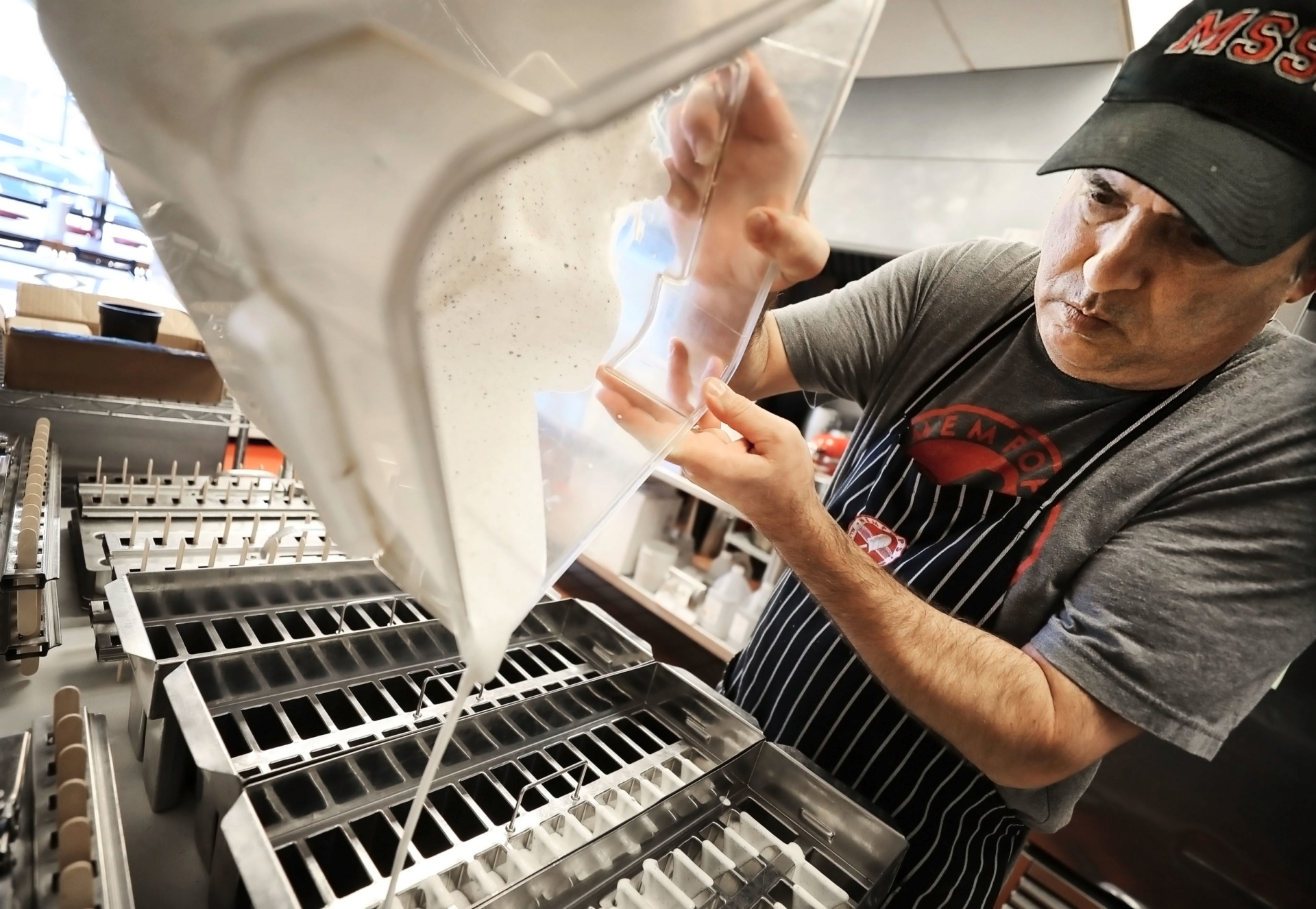 <strong>Shawn Herrington, store manager for the Mempops location on Ridgeway, mixes up a batch of cookies and cream treats on Feb. 8, 2019. Mempops is expanding by establishing a production kitchen on Summer Ave. to help streamline the production of popsicles.</strong> (Jim Weber/Daily Memphian)