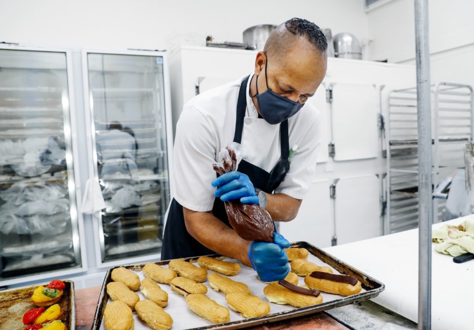 <strong>La Baguette baker Kevin White decorates eclairs on Wednesday, Sept. 8.</strong> (Mark Weber/The Daily Memphian)