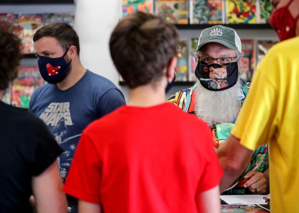 <strong>The co-owners of 901 Comics, Jaime Wright (left) and Shannon Merritt, help customers check out on Aug. 28 at the shop&rsquo;s Cordova location.</strong> (Patrick Lantrip/Daily Memphian)